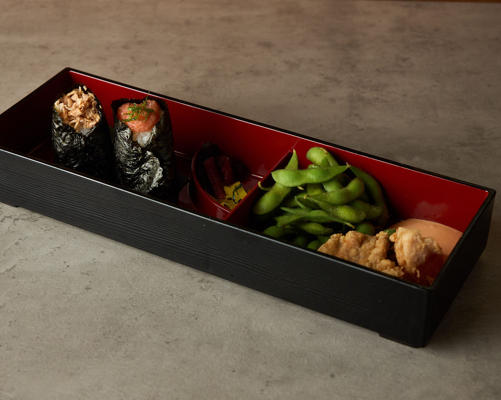 Onigiri bento box with two rice balls, miso soup and pickles